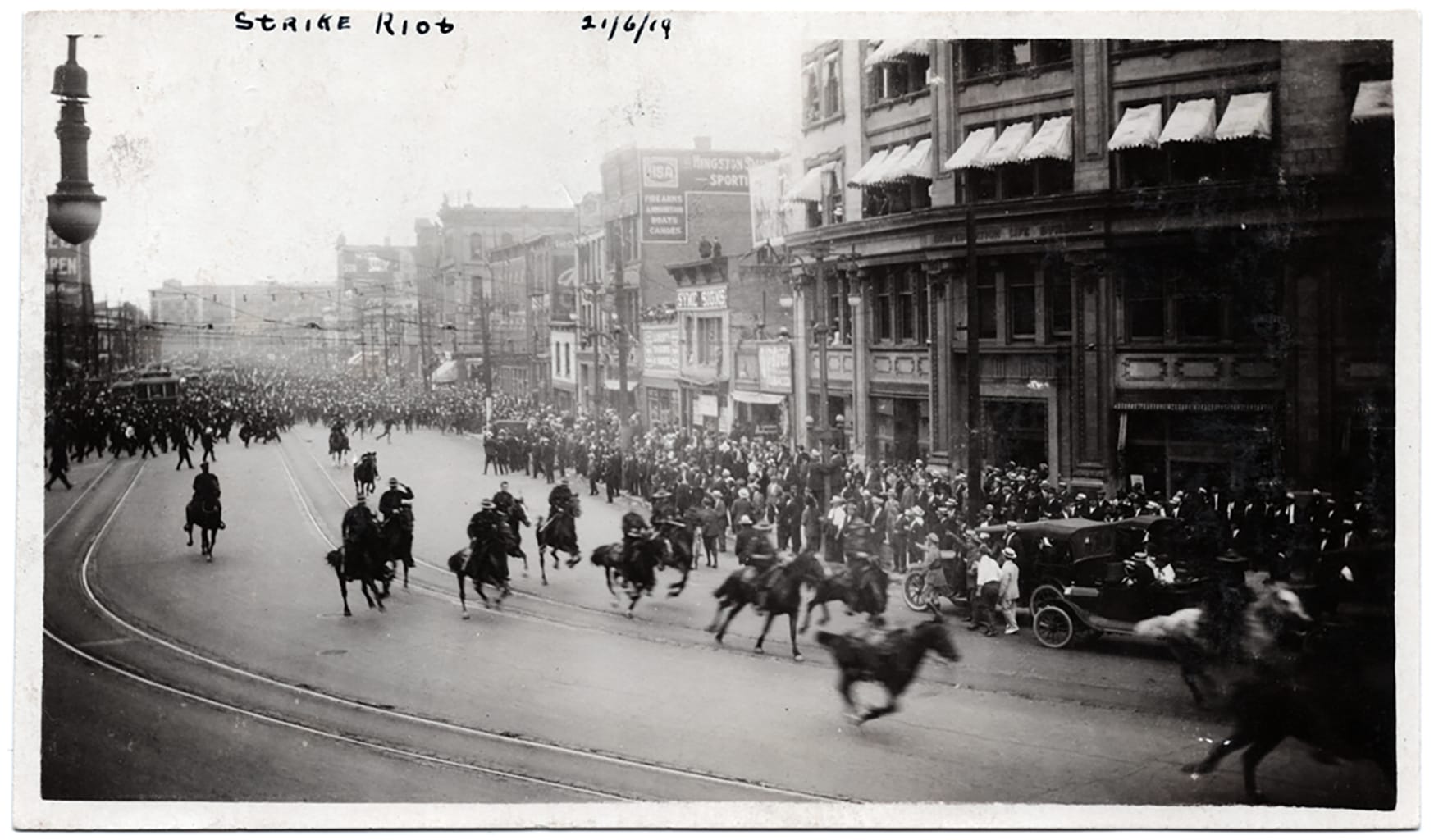 Black and white archival photo of police on horseback charging during 1919 strike