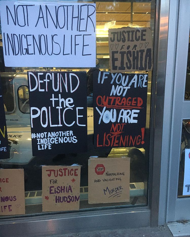 protest posters on Winnipeg police headquarters